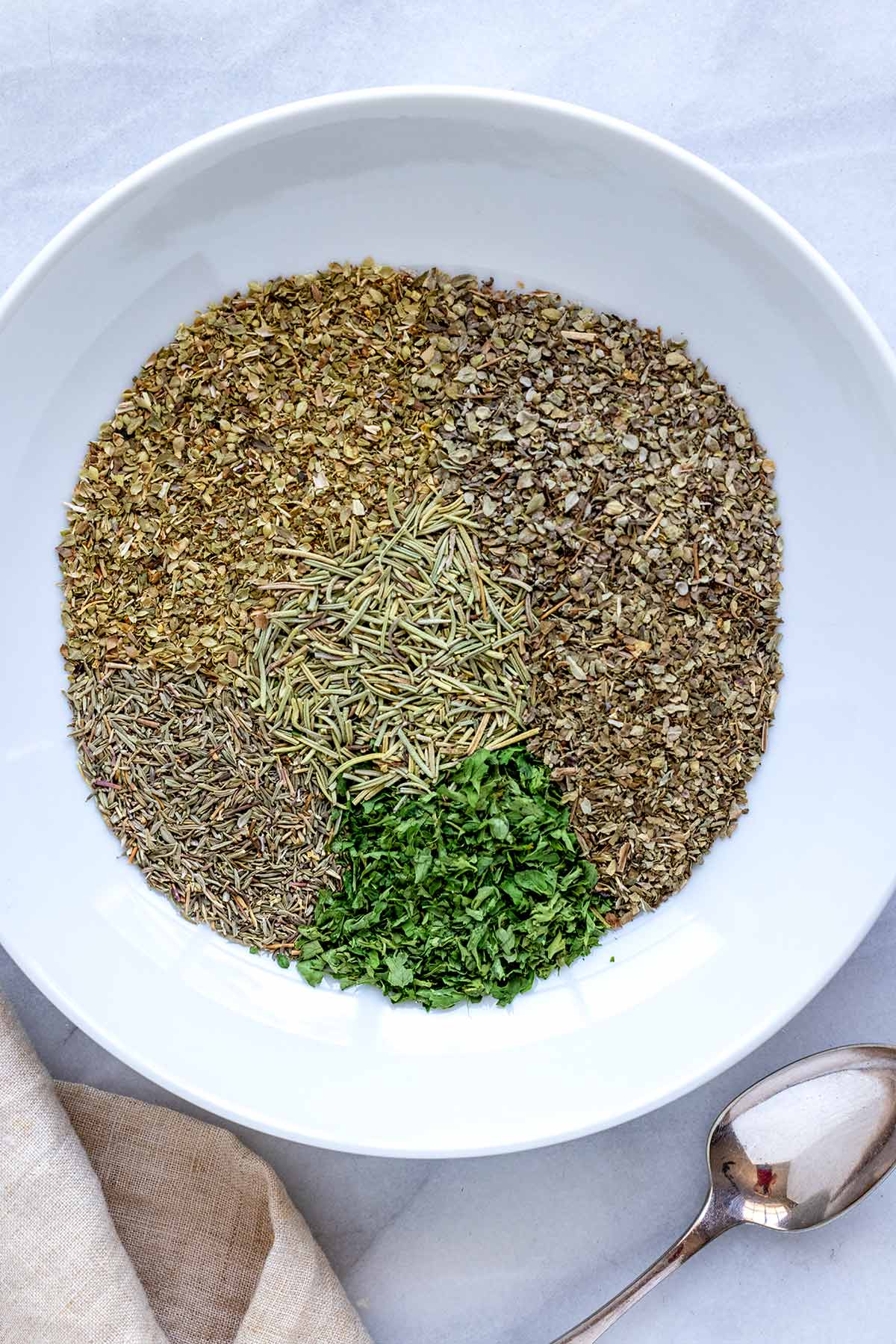 Several dried spices in a white bowl.