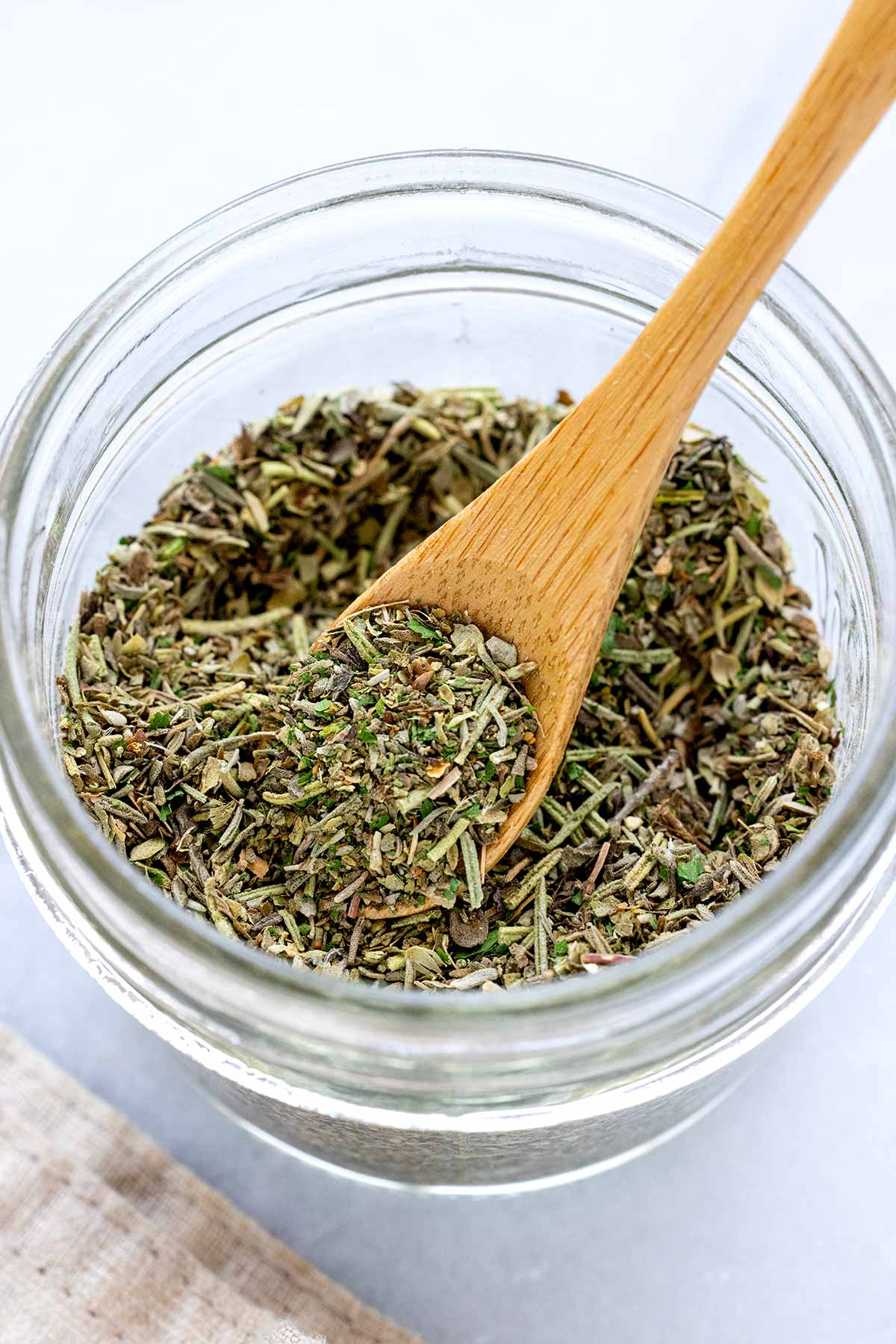 Homemade Italian seasoning in a glass jar.
