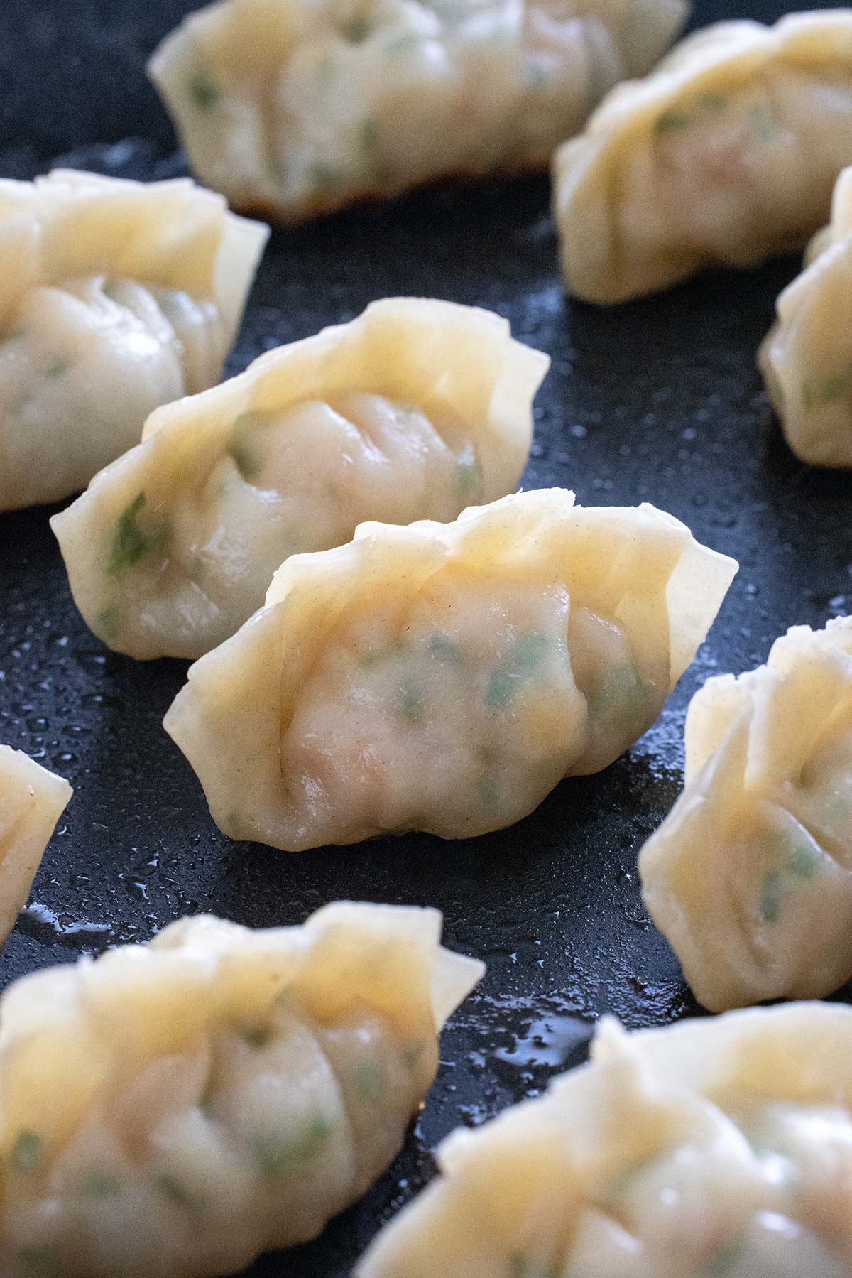 Cooked shrimp dumplings in a pan.