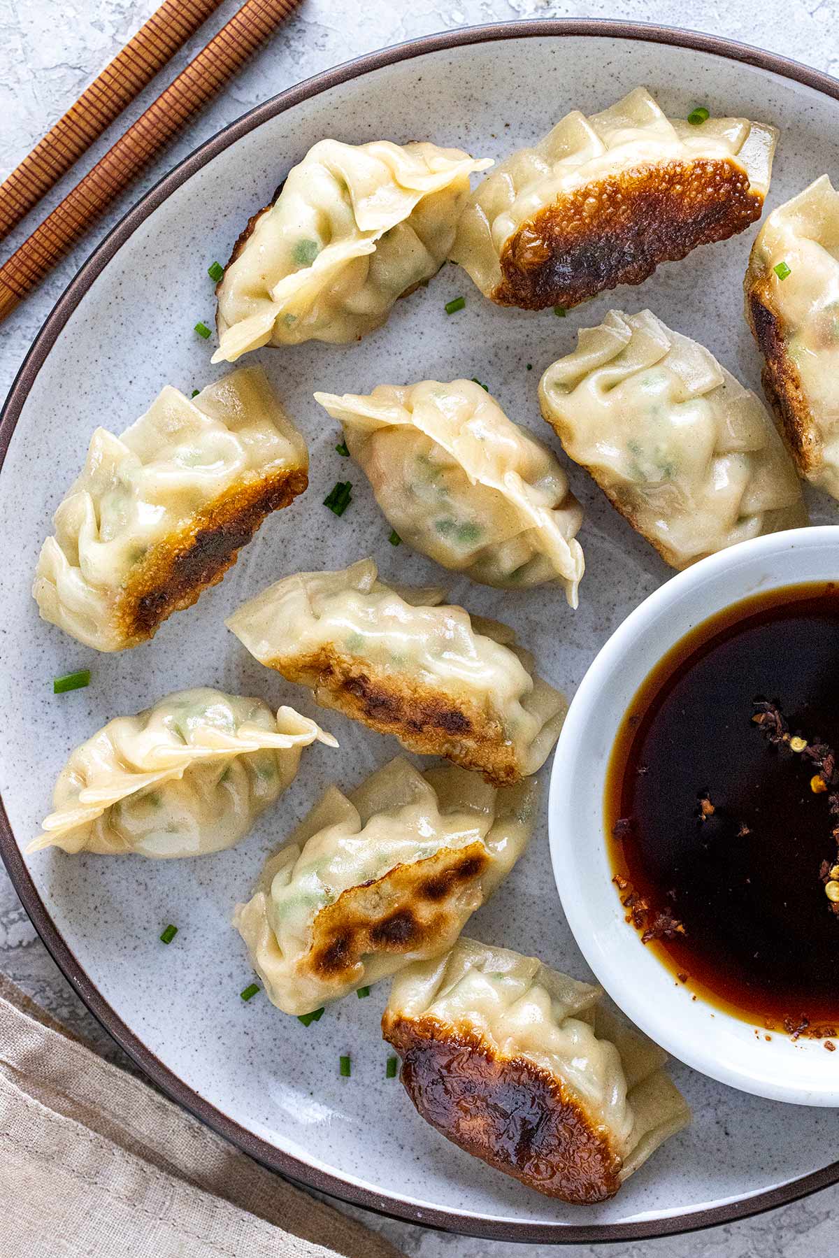 Plate of homemade shrimp dumplings with dipping sauce.