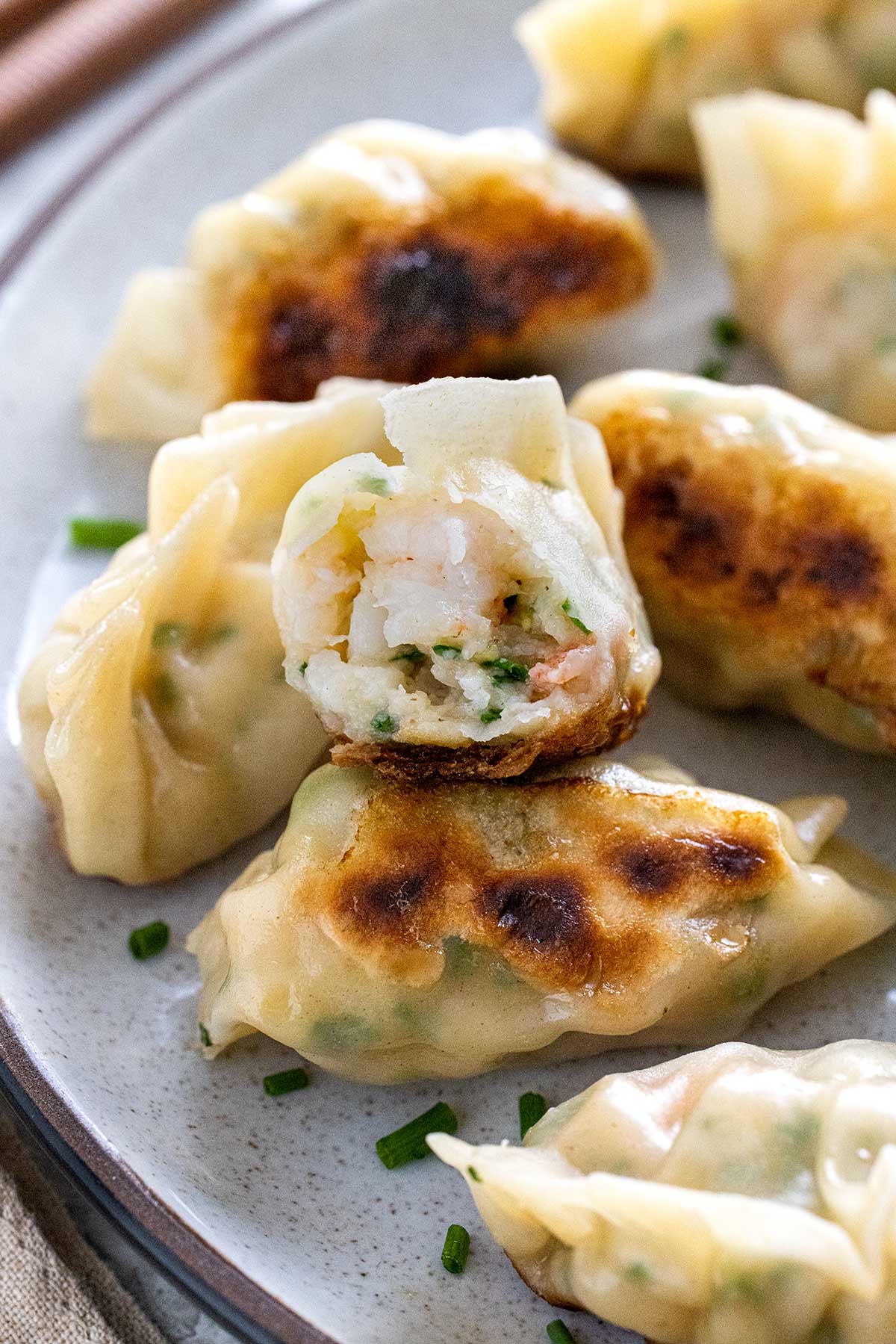 Shrimp dumpling cut in half showing the filling inside.