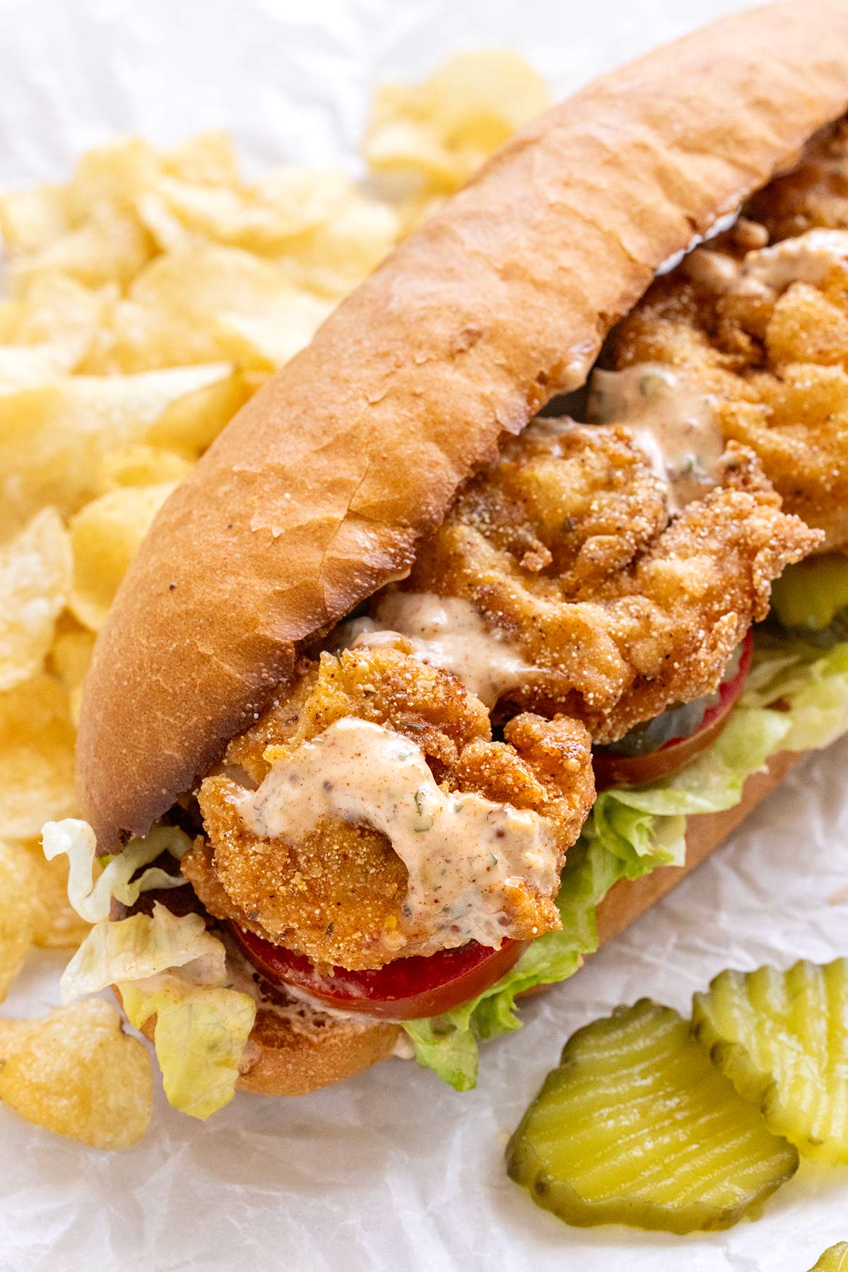 Shrimp Po Boy served with a side of potato chips.