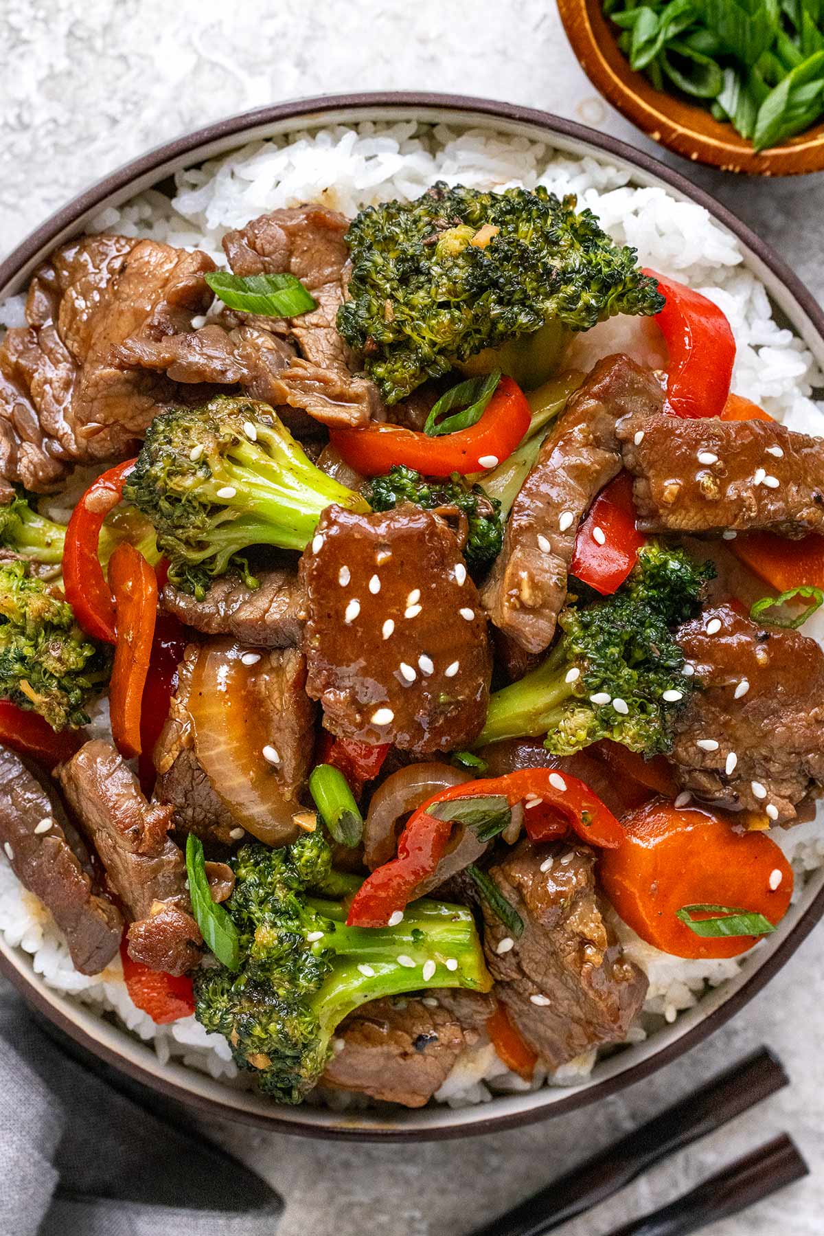 Bowl of beef stir fry in a bowl with white rice.