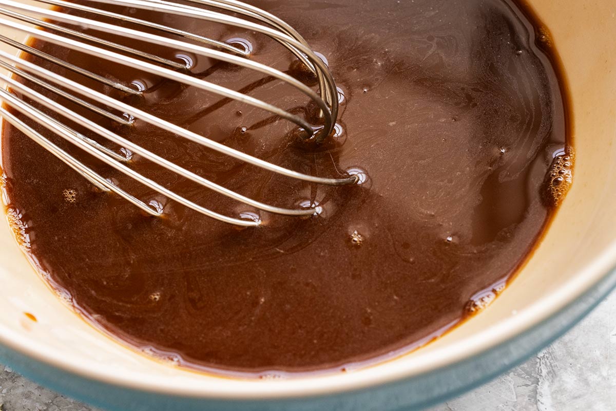 Stir fry sauce being whisked in a bowl.