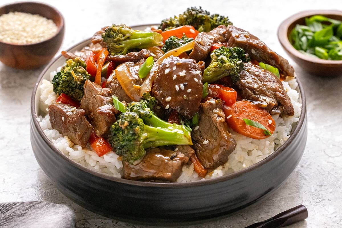 Bowl of homemade beef stir fry served on steamed white rice.