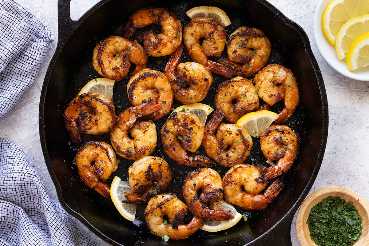 Cooked shrimp with blackened surfaces.