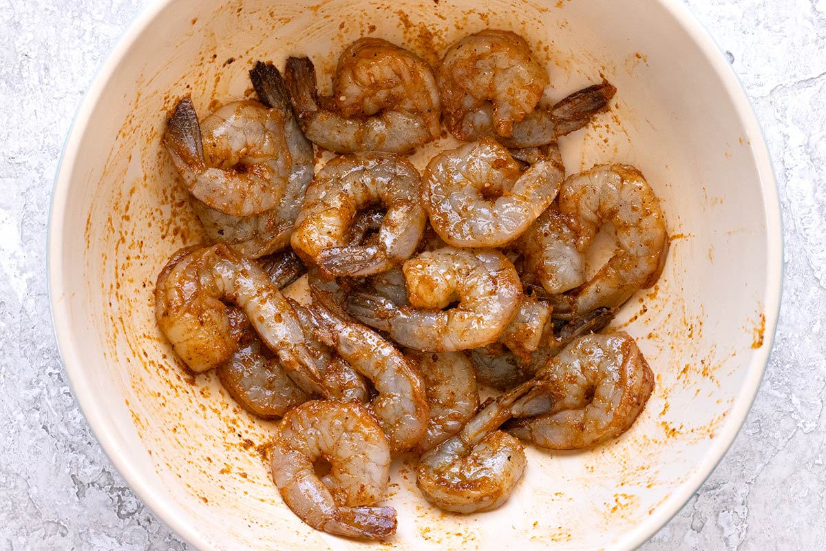 Shrimp in a bowl coasted in dried spices.