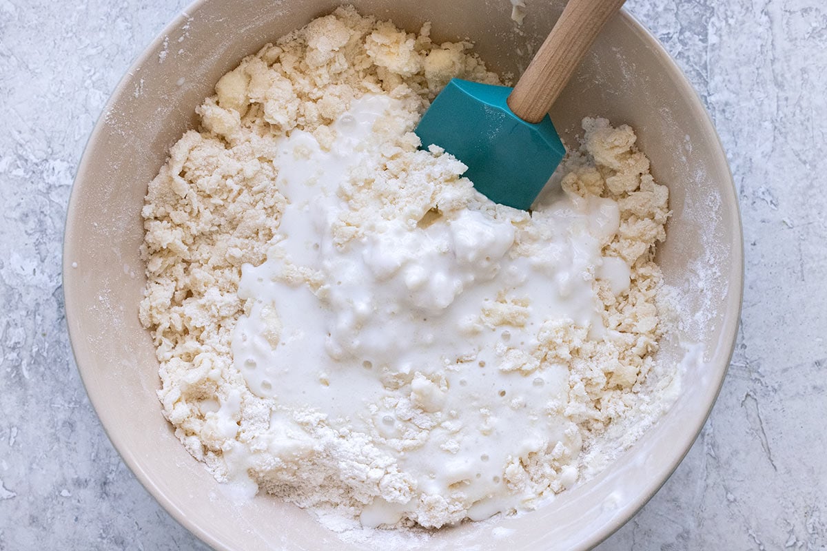 Mixing bowl with flour, butter, and buttermilk.