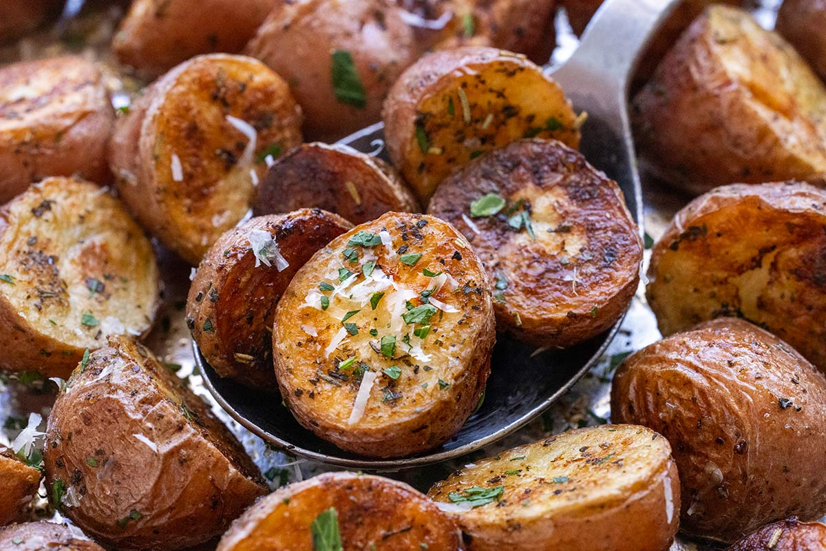 Grilled potatoes garnished with parmesan and parsley.