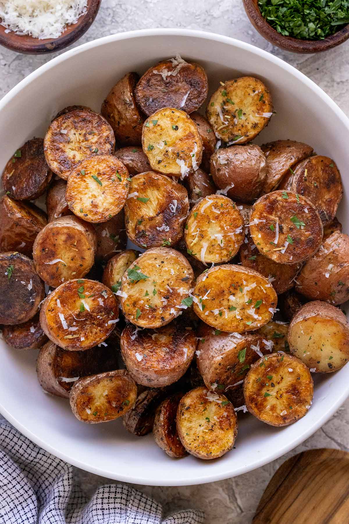 Grilled potatoes served in a white bowl.