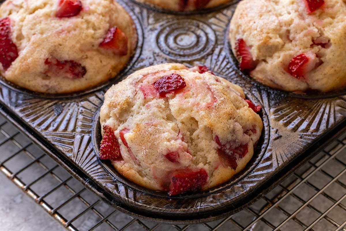 Strawberry muffins in a baking tin.