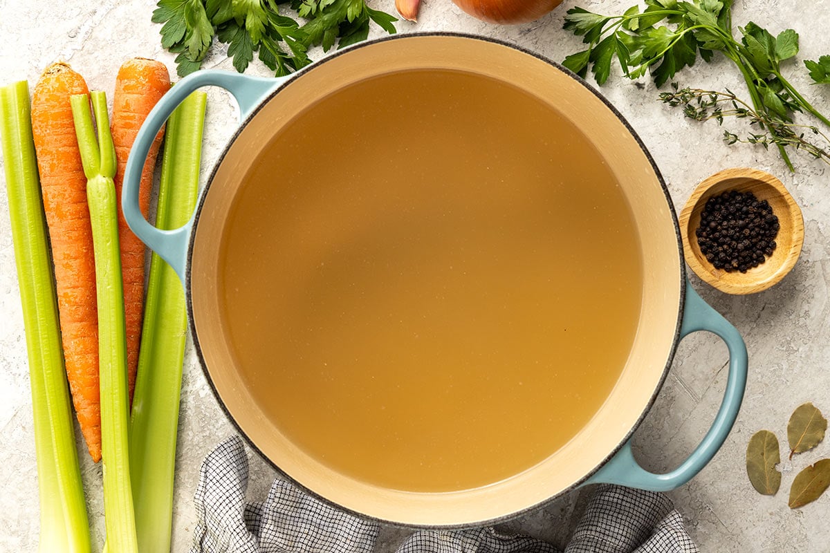 Pot of homemade chicken stock ready to use for recipes.