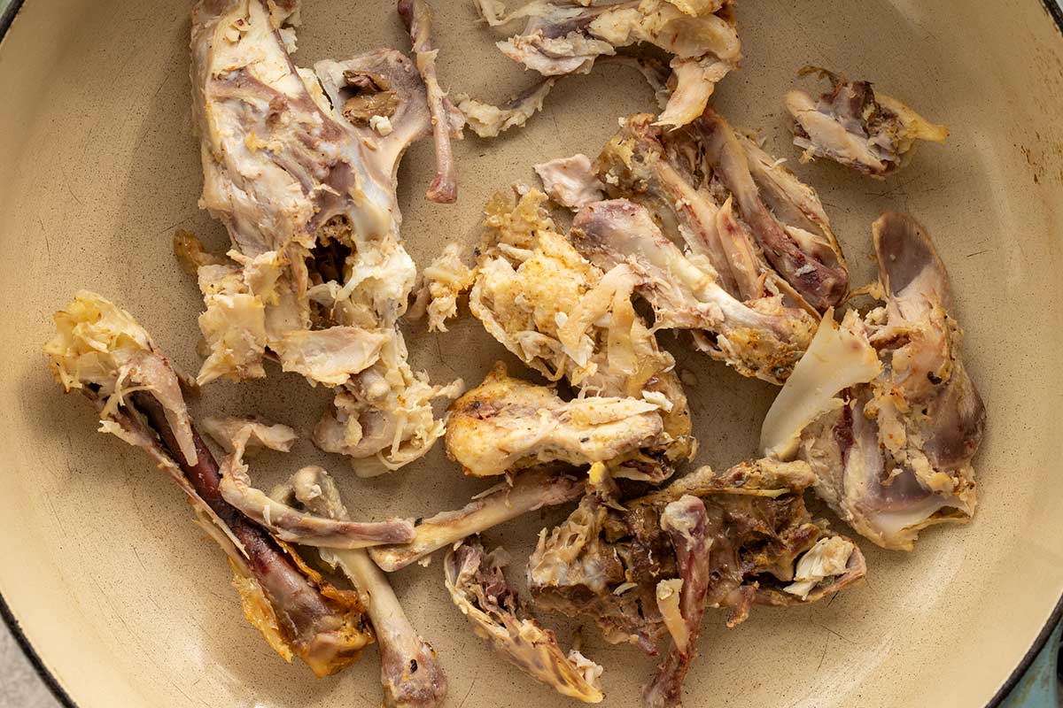 Chicken bone pieces inside a pot.
