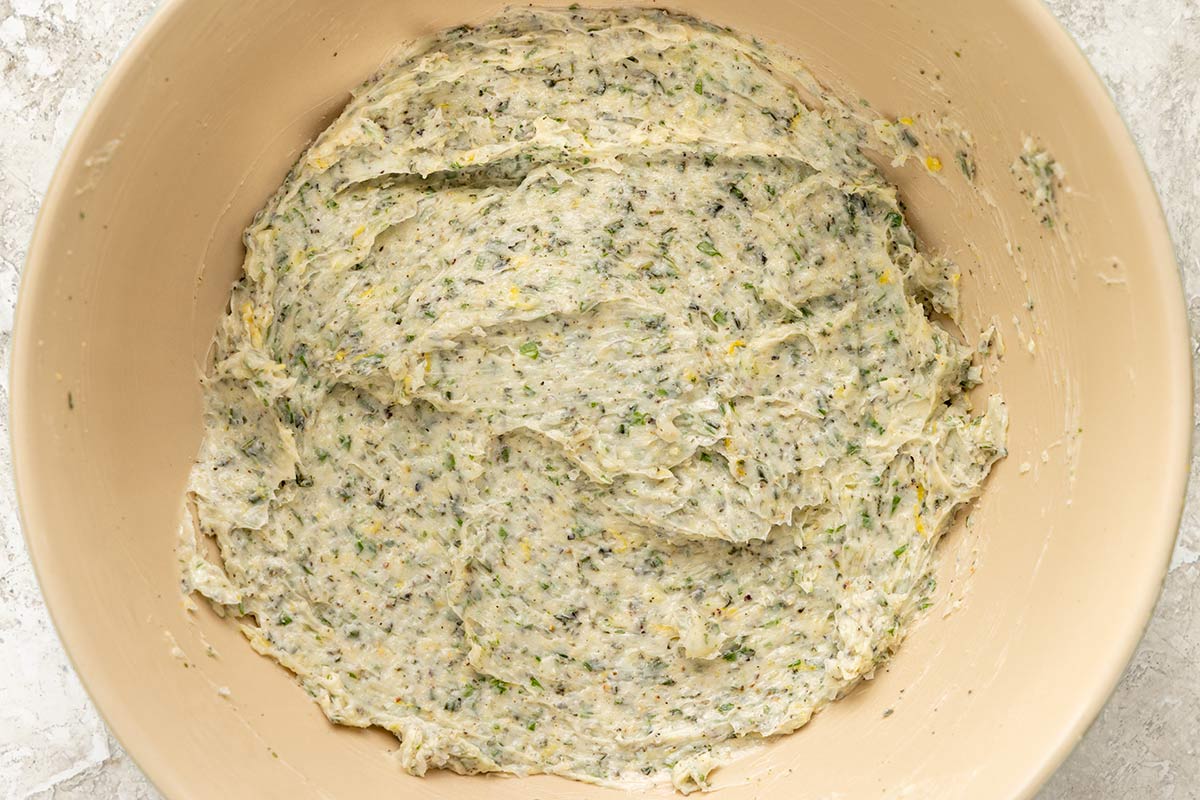 Herb compound butter in a mixing bowl.