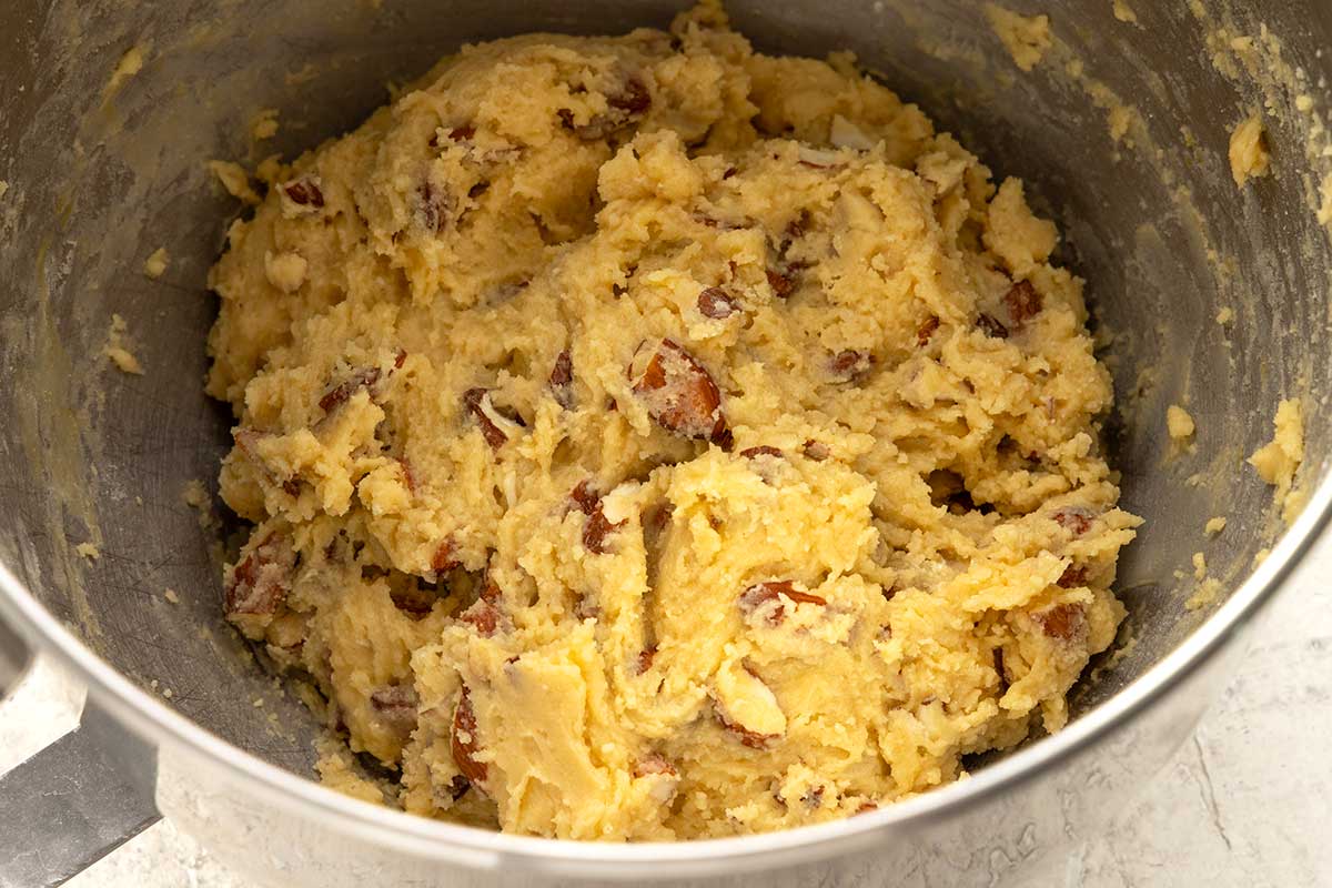 Biscotti cookie dough in a stand mixer bowl.