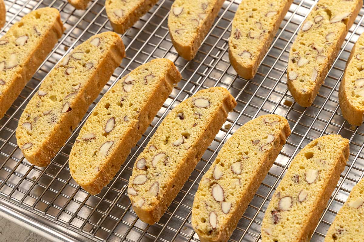 Pieces of biscotti lined up on a wire rack.