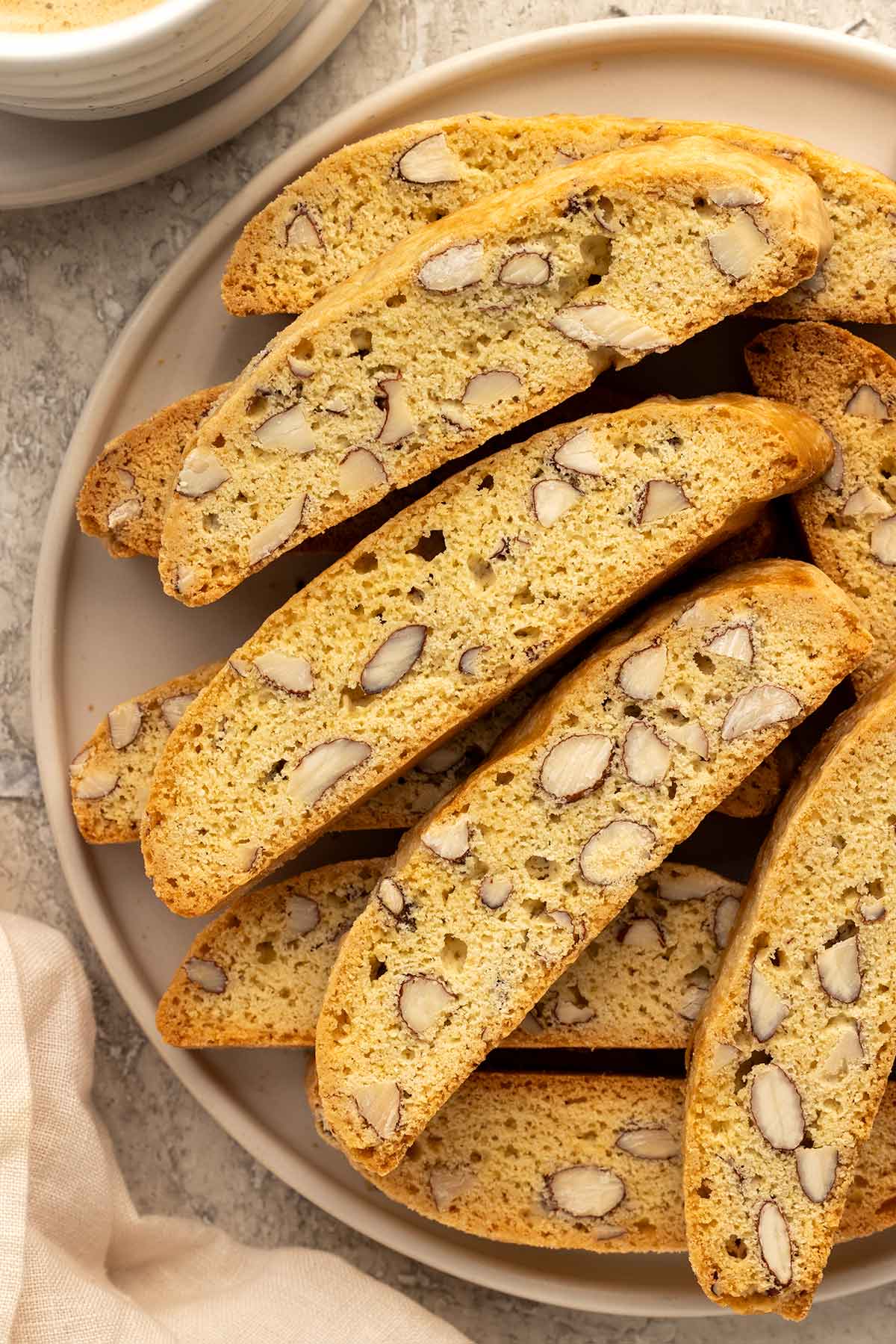Plate of homemade almond biscotti showing the almonds within each cookie.