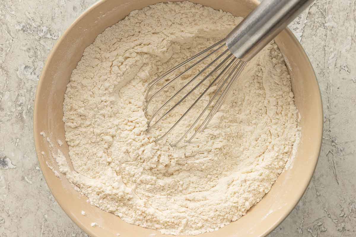 Whisk in the middle of a mixing bowl with flour and baking powder.