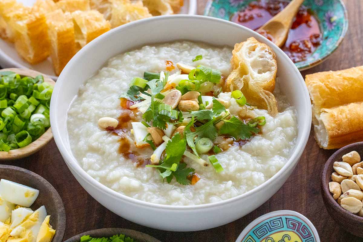 Bowl of basic congee served with several different toppings.