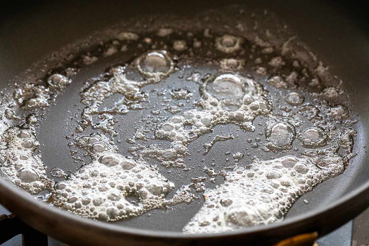 Melted butter bubbling in a hot pan.
