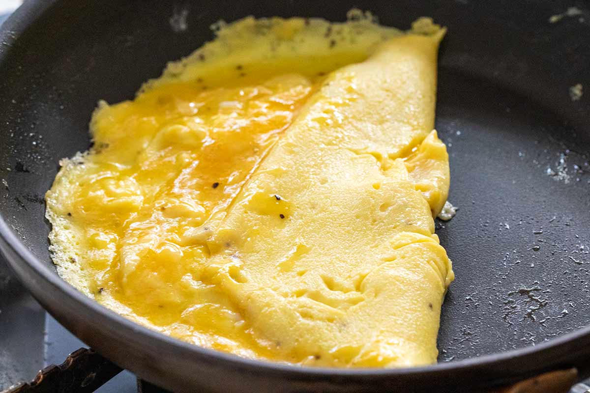 Eggs in a pan with one side folded over the other.