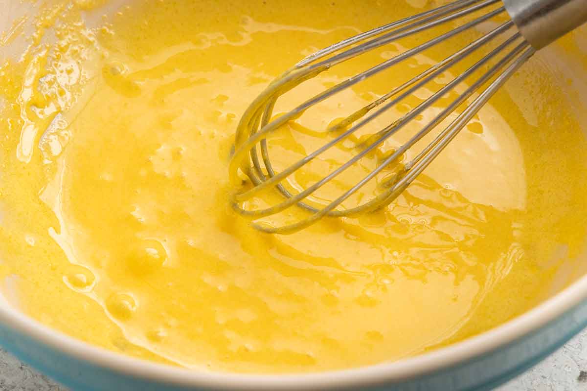 Whisk in the middle of a bowl of egg yolks.