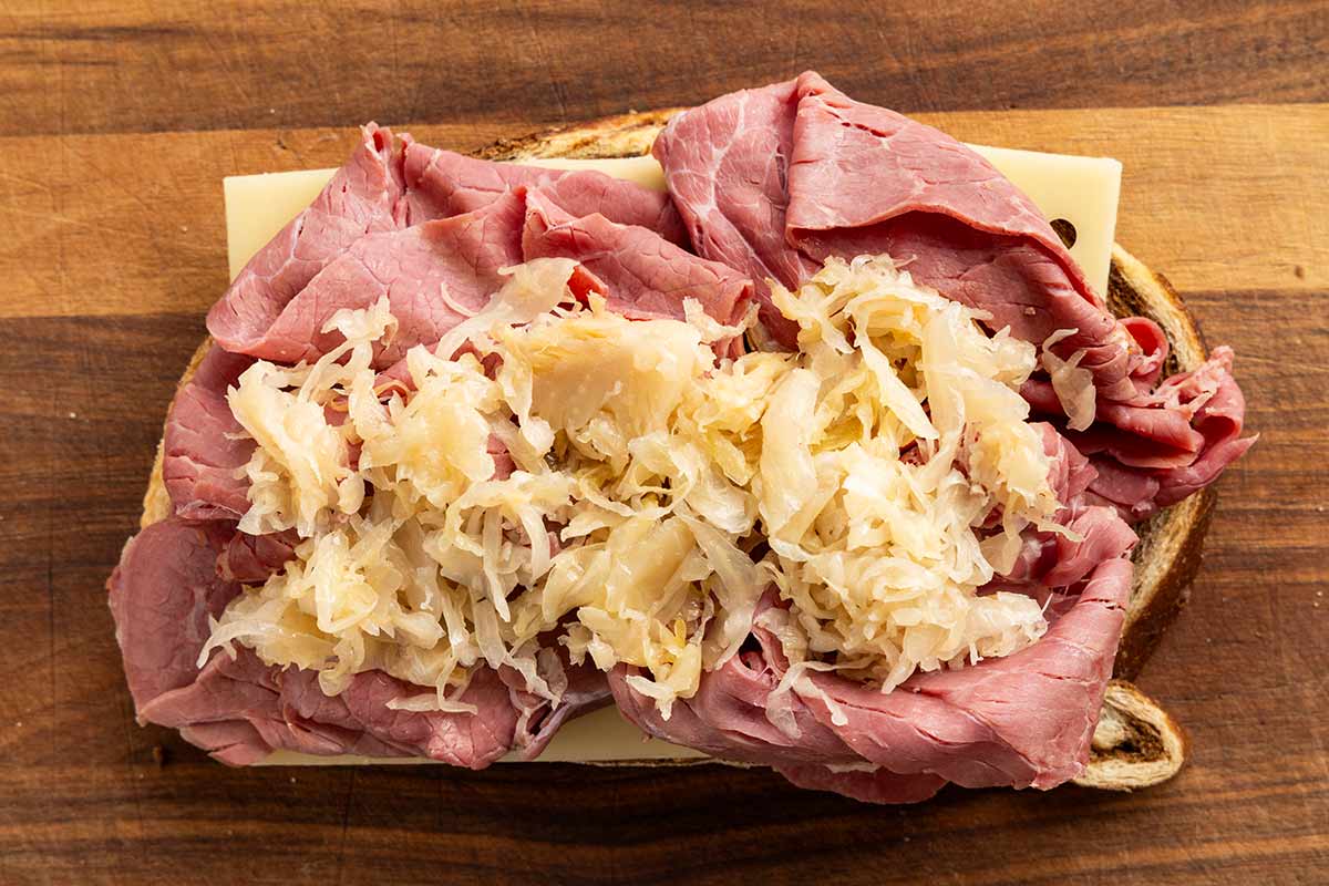 Sauerkraut, corned beef, swiss cheese, placed on a slice of marble rye bread.