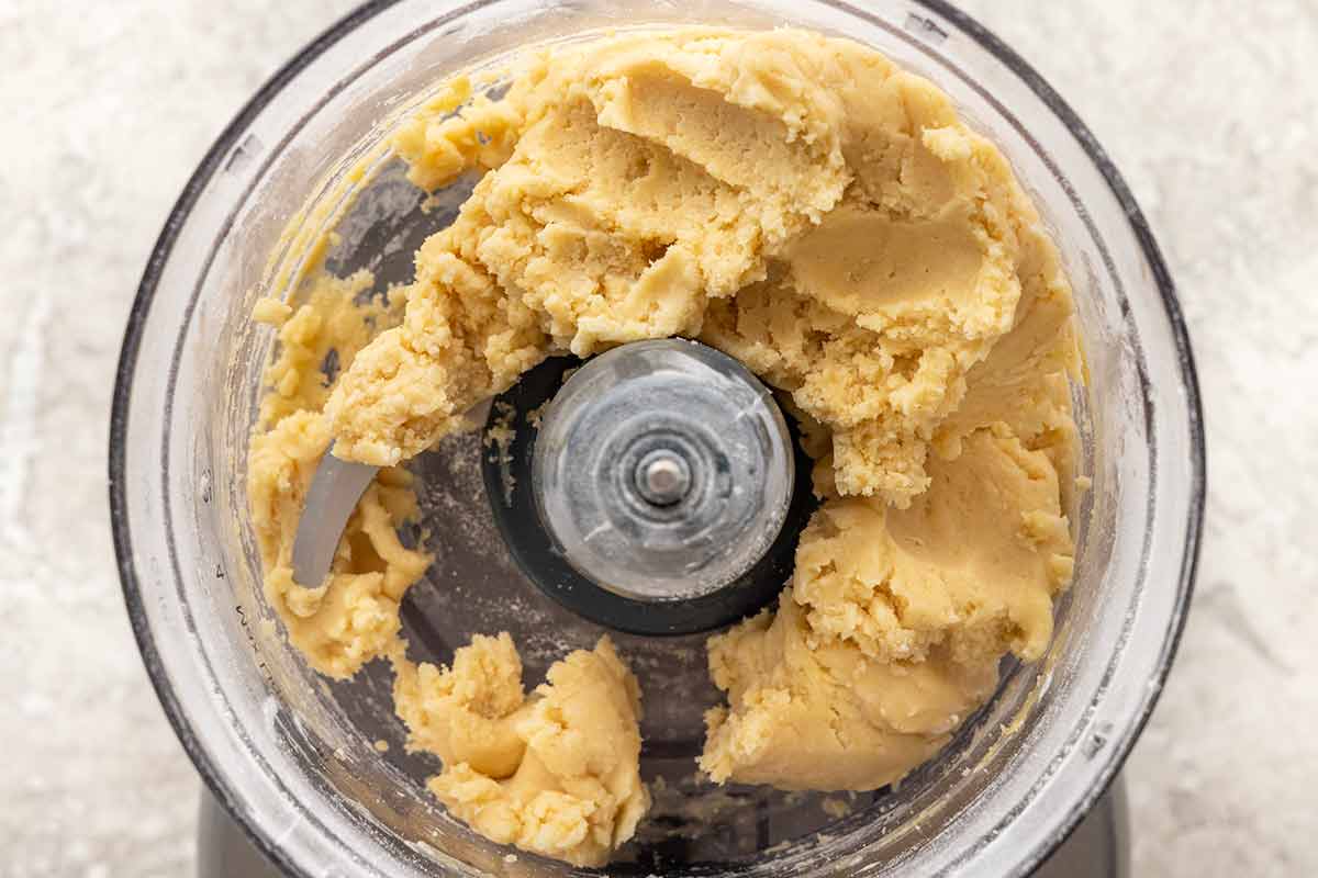 Tart crust dough inside a food processor.