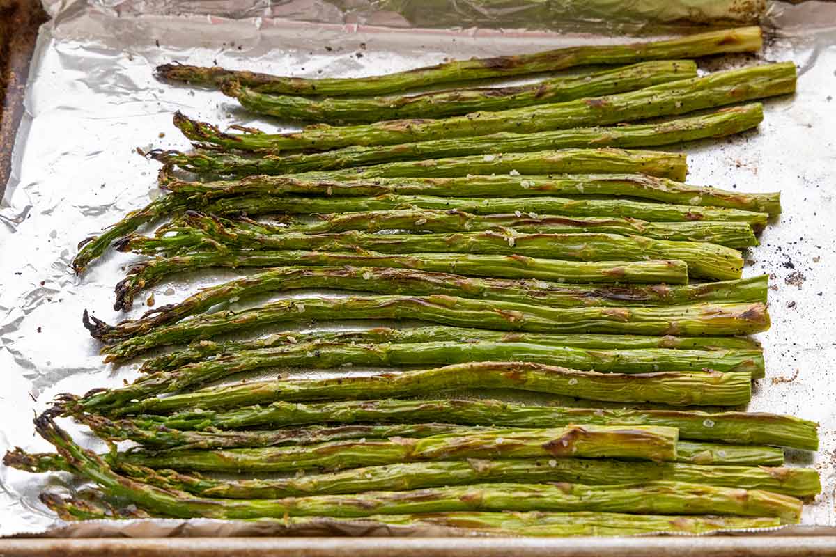 Broiled asparagus on a sheet pan.