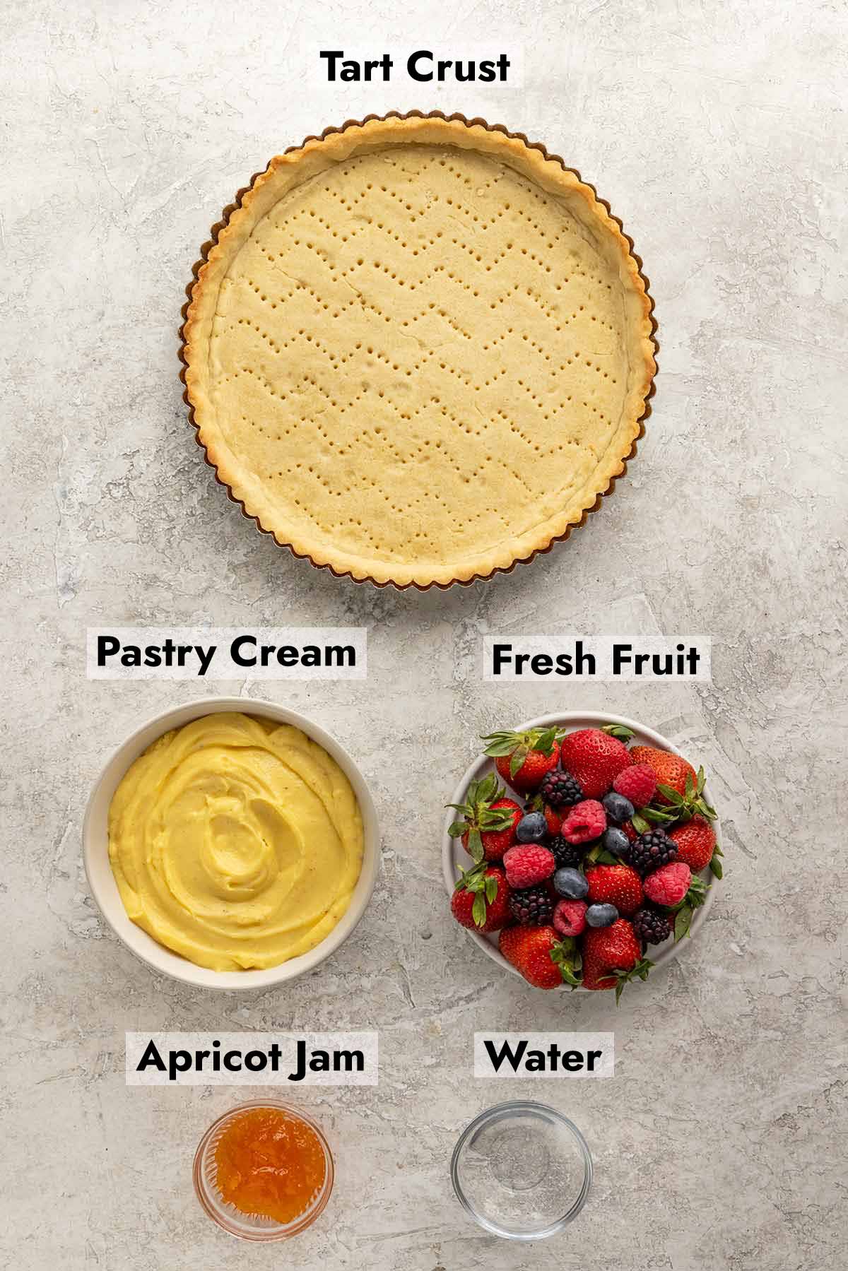 Tart crust, bowl of pastry cream, bowl of fresh fruit, bowl of apricot jam, and a small bowl of water.