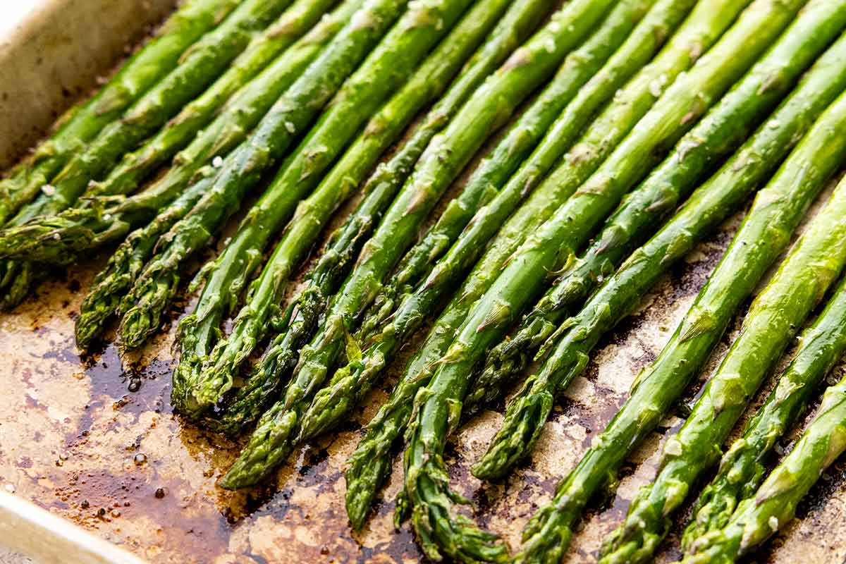 A pan of roasted asparagus with browned edges.