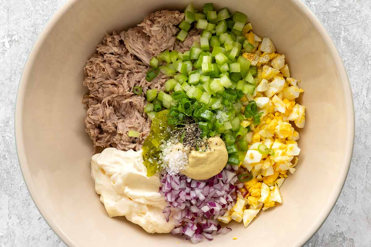 Unmixed tuna salad ingredients in a bowl.