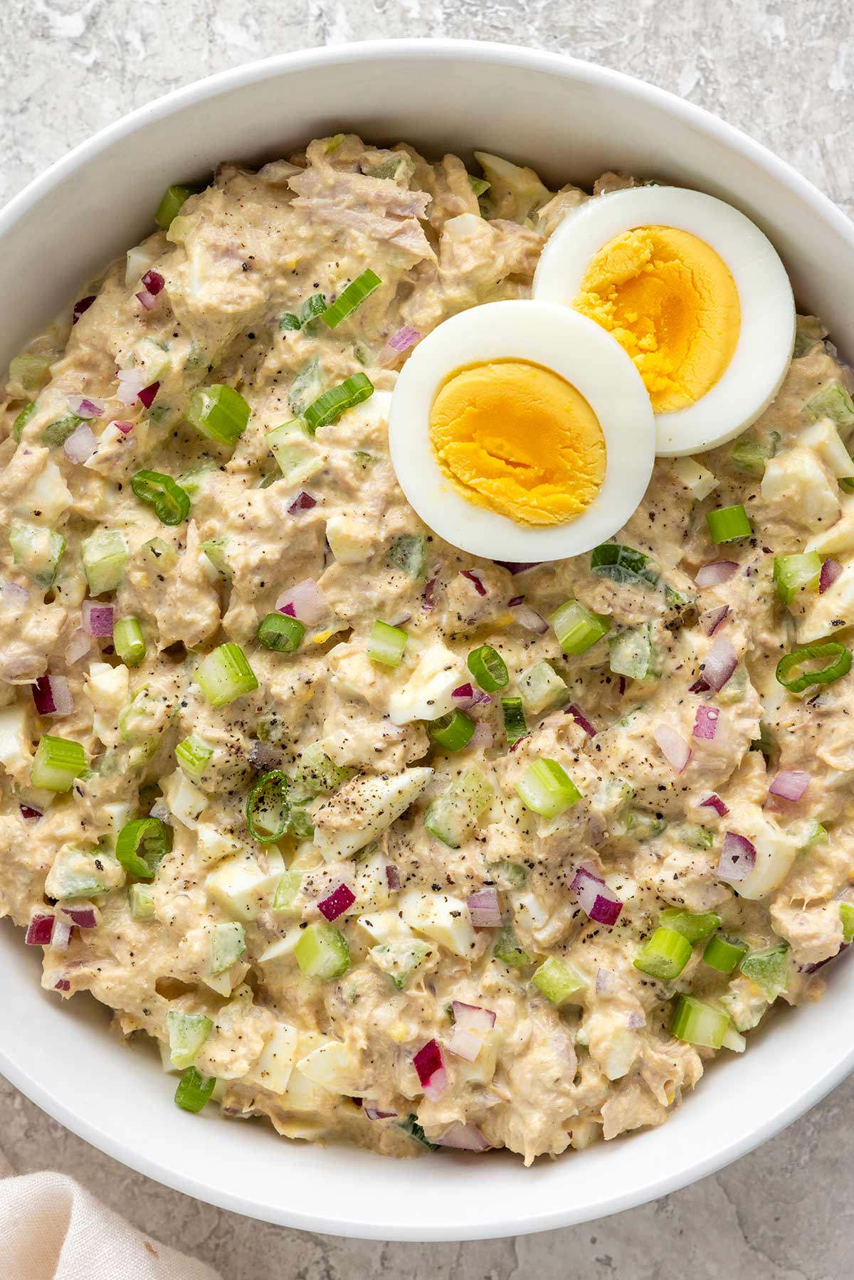 Tuna egg salad in a white bowl.