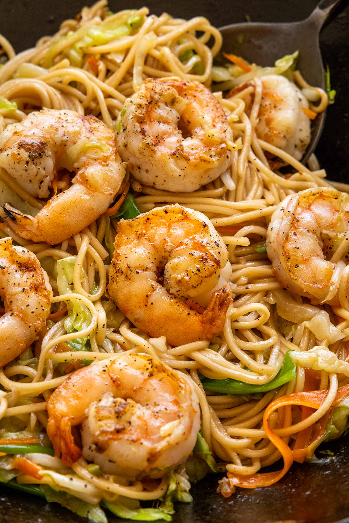 Delicious shrimp lo mein cooking in a wok.