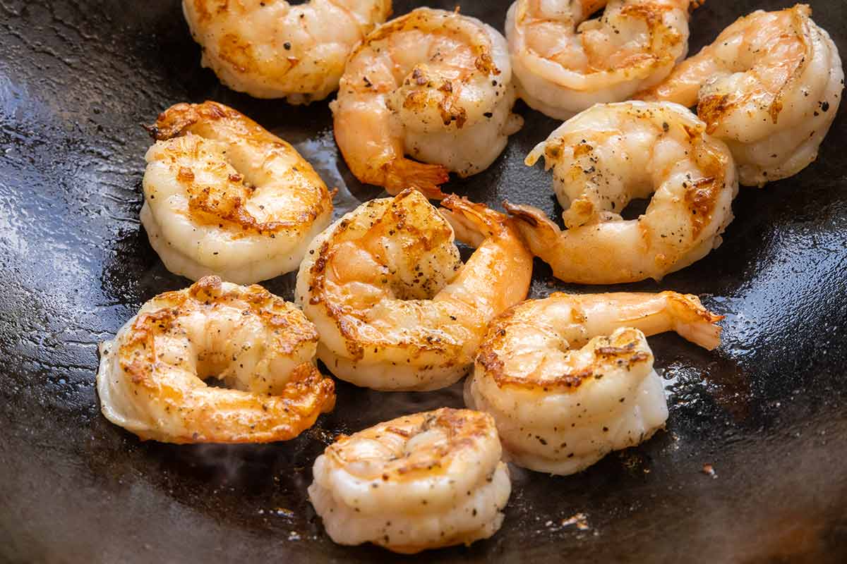 Sauteed shrimp cooking in a wok.
