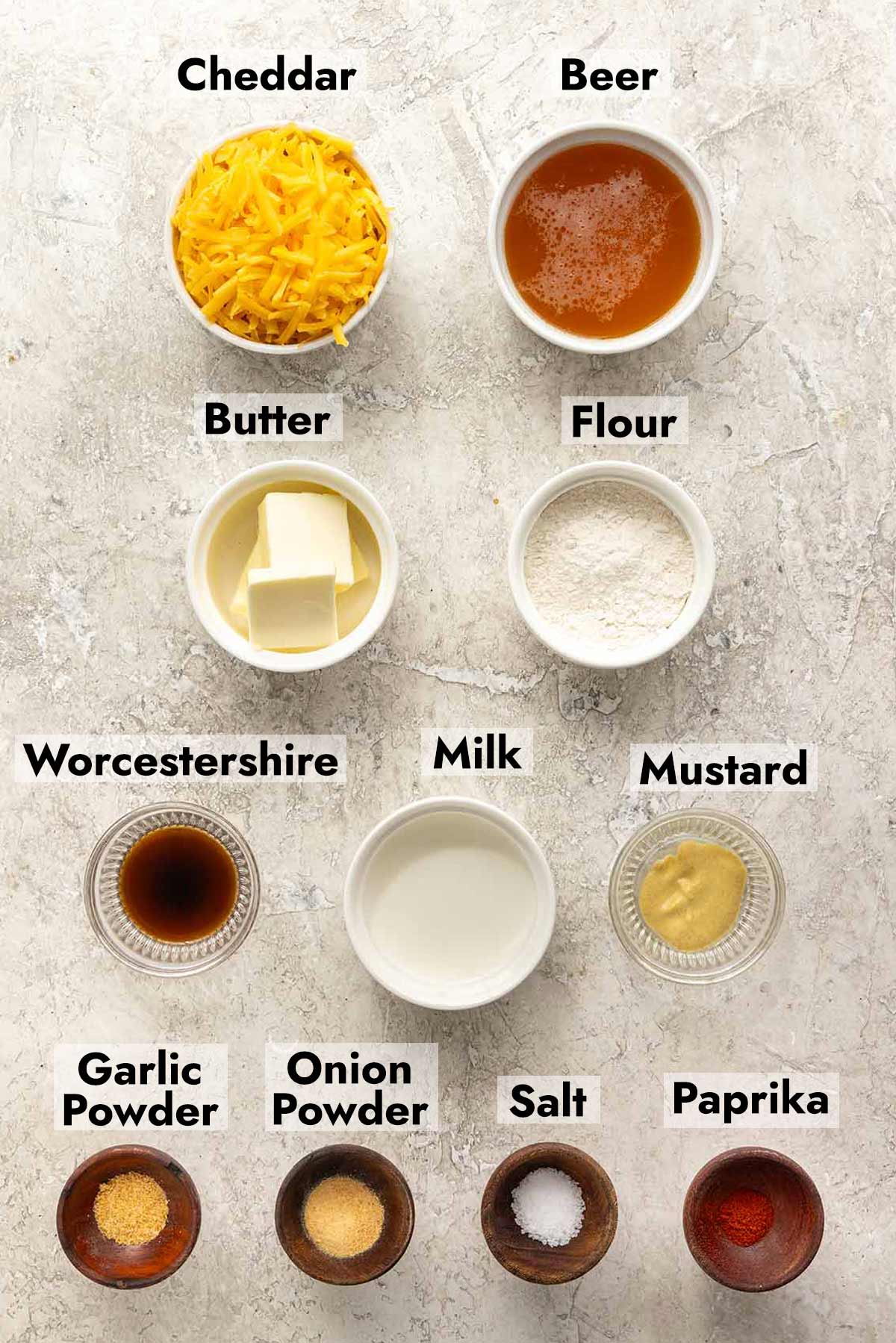 Labeled ingredients for beer cheese dip, including sharp cheddar and wheat beer.