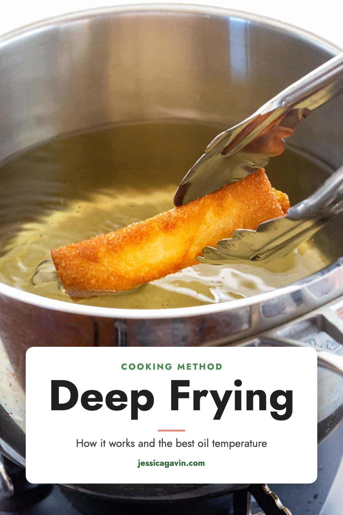 Tongs lifting a golden, crispy egg roll out of a pot of hot oil.